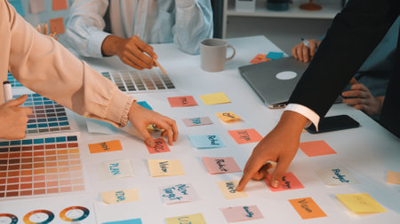 A vibrant workspace showcasing a team engaged in a brainstorming session. Colorful sticky notes and...