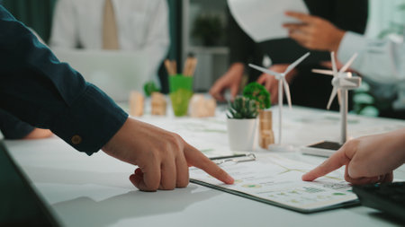 A dynamic business meeting in a modern office setting where team members collaborate on project plans, focusing on innovative and sustainable solutions for future growth.の写真素材