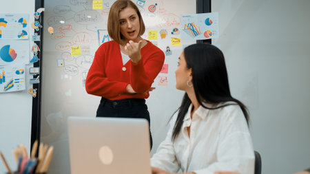 Skilled young beautiful project manager suggest, comment on creative businesswoman marketing strategy. Professional business team discussion, working together, brainstorming. Immaculate.の写真素材
