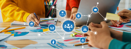 A vibrant workspace featuring colorful charts, technology, and hands collaborating over documents,...