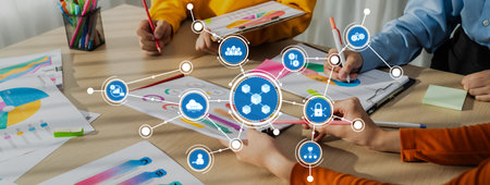 A group of diverse individuals collaborates at a table, engaging in data analysis and creative...