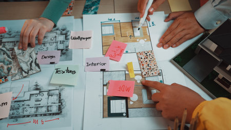 A vibrant workspace showcasing a collaborative approach to interior design. Hands actively engage...
