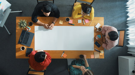 Top view of diverse group walking at boardroom and brainstorming idea. Smart startup team sharing marketing idea while project manager standing at whiteboard and present financial plan.の写真素材