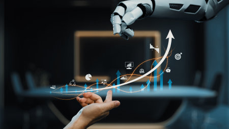 A robotic hand extends towards a human hand in a modern office setting, symbolizing collaboration in the digital landscape. The graphic displays a business growth chart with icons.の写真素材