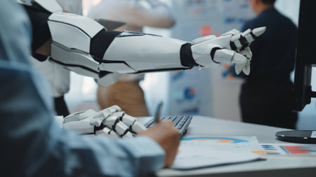 A robotic arm points at graphical reports while a human writes notes in a modern office, showcasing the synergy between advanced technology and human expertise in business settings.の写真素材