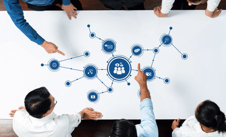Professionals engaging in a collaborative business discussion focused on media strategies,...