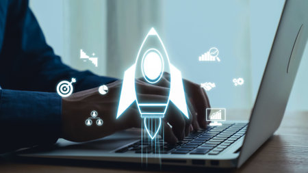 A professional individual works on a laptop, surrounded by digital rocket imagery, representing innovation and growth for startups within a modern workspace environment.の写真素材