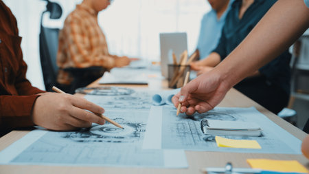 A dynamic group of creative professionals engages in collaborative design efforts at a modern...
