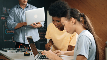 Group of diverse student working together to write program. Multicultural children coding or...