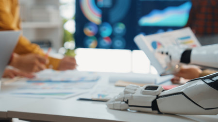 A modern office scene where diverse professionals collaborate on data analysis. A robotic arm is...