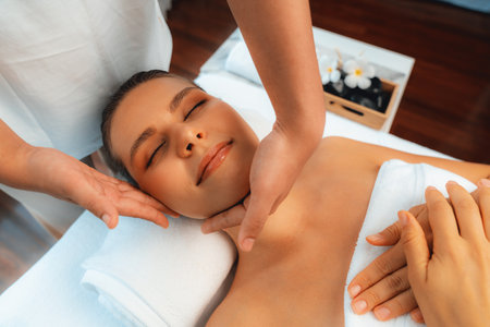 Caucasian woman enjoying relaxing anti-stress head massage and pampering facial beauty skin recreation leisure in dayspa modern light ambient at luxury resort or hotel spa salon. Quiescentの写真素材