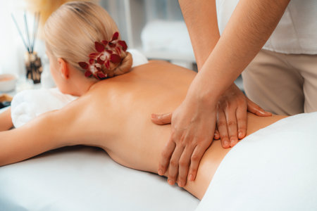Caucasian woman customer enjoying relaxing anti-stress spa massage and pampering with beauty skin recreation leisure in day light ambient salon spa at luxury resort or hotel. Quiescentの写真素材