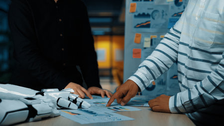 Two business professionals are engaged in a focused collaboration over data analysis in a modern...