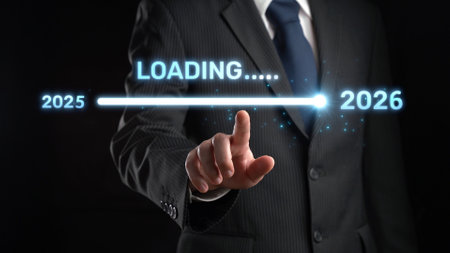 A businessman is depicted in a dark setting, interacting with a futuristic loading bar that shows the transition from the year 2025 to 2026, symbolizing anticipation.の写真素材