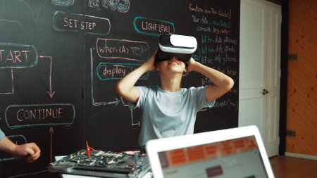Closeup of african student coding or programing system at blackboard with web develop plan while young girl playing in metaworld at blackboard with engineering prompt. Innovation. Edification.の写真素材