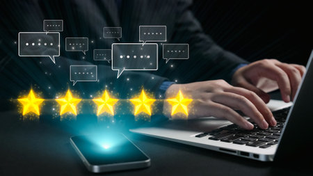 A close-up image of hands typing on a laptop, accompanied by floating five-star ratings and speech...
