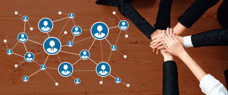 A dynamic scene depicting collaboration and networking, showcasing hands joining on a wooden table with graphical connections representing thriving professional relationships.の写真素材