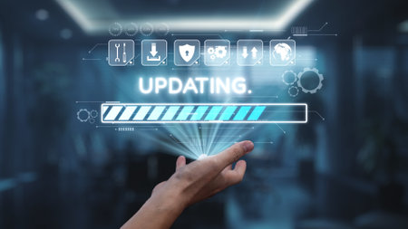 A hand reaches towards a virtual progress bar indicating an updating status, accompanied by various graphical icons, set against a sleek office background.の写真素材