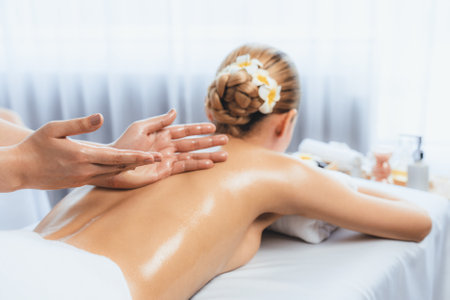 Caucasian woman customer enjoying relaxing anti-stress spa massage and pampering with beauty skin recreation leisure in day light ambient salon spa at luxury resort or hotel. Quiescentの写真素材