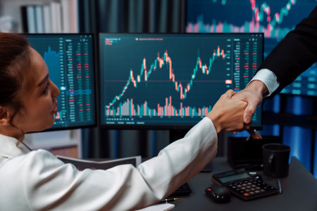 Successful businesswoman checking hand with getting stock market profit to cropped hand partner...