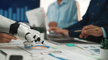 A robot hand reaches for data charts in a vibrant business meeting, showcasing the integration of...