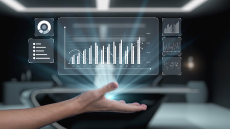 A hand holds a glowing data interface displaying intricate graphs and charts, representing analytics...