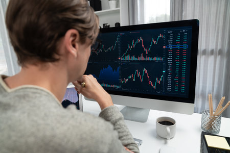Business trader using computer and laptop to search highest profit value of dynamic increased stock...