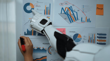A futuristic robotic hand points at detailed charts and graphs on a wall, showcasing data insights...