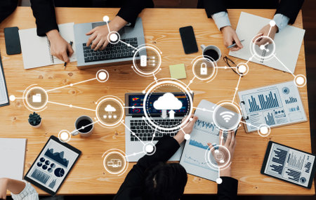 Engaging scene of a collaborative computing meeting where participants utilize laptops and data visuals to enhance teamwork and decision-making.の写真素材