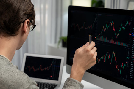 Stressful businessman casual day looking on dynamic stock exchange market graph on pc screen at...