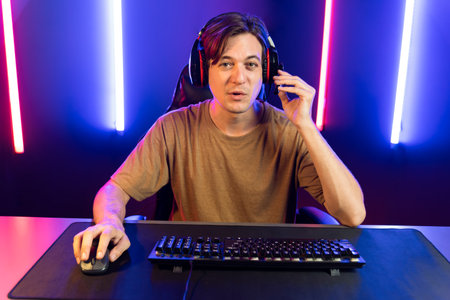 Host channel of gaming streamer playing online game to be winner, wearing headphone with viewers...