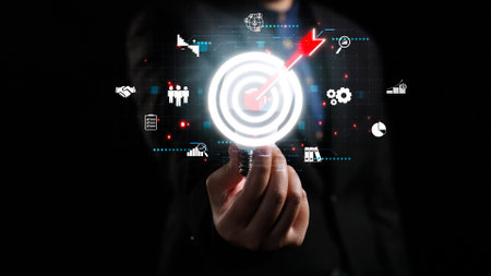 A businessman engages with a glowing target icon amidst analytical graphics, emphasizing the importance of strategy and technology for growth and success in business.の写真素材