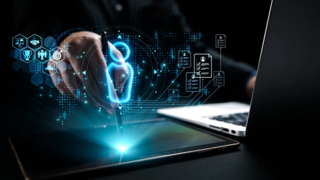 A professional engages with a digital tablet and laptop, featuring a futuristic holographic interface that represents technology and creativity seamlessly converging.の写真素材