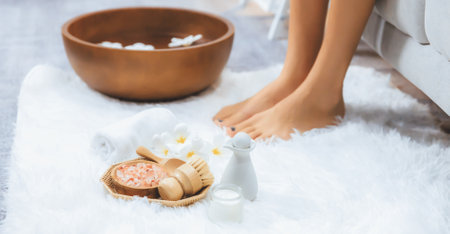 Panorama top view woman indulges in blissful foot massage at luxurious spa salon while masseur give reflexology therapy in gentle day light ambiance resort or hotel foot spa. Quiescentの写真素材