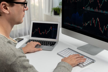 Stressful businessman casual day looking on dynamic stock exchange market graph on pc screen at...