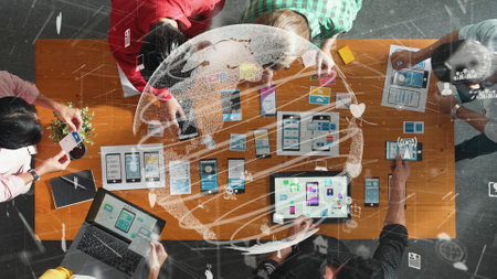 Top aerial view of skilled business team working together to design Ux Ui. Group of diverse people brainstorming and discussing about global communication by using big database.の写真素材