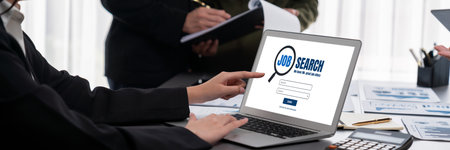 Panorama shot analyst team utilizing BI to analyze financial report with laptop. Businesspeople analyzing BI data dashboard displayed on laptop screen for business insight.の写真素材