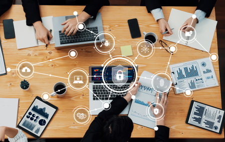 A group of professionals collaborates during a focused business meeting on cybersecurity strategies,...