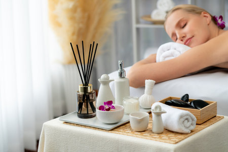 Caucasian woman customer enjoying relaxing anti-stress spa massage and pampering with beauty skin recreation leisure in day light ambient salon spa at luxury resort or hotel. Quiescentの写真素材