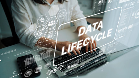 Professional Woman Typing on Laptop with Data Lifecycle Graphics Overlaying Modern Office Environment. Asymptotic smart data analytic.の写真素材