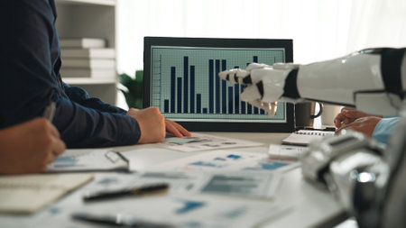A dynamic office scene showcasing teamwork, where individuals collaborate with futuristic robotic technology and data analytics to drive business strategies effectively.の写真素材