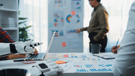 Team of business professionals engaged in a collaborative session in a modern office, utilizing a...