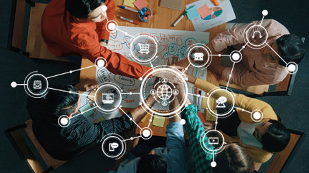 A top-down view of a dynamic team engaged in a planning session, using visual diagrams and...