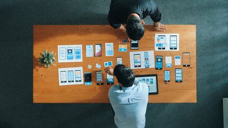 Top view of software developer working on Ux Ui design while team working together to brainstorm and develop wireframe prototype designing at creative digital company. Teamwork concept. Convocation.の写真素材