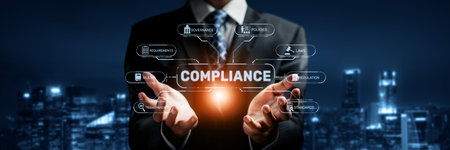 A businessman showcases a compliance concept with a digital interface against an urban backdrop at night. This image highlights the importance of corporate governance and regulations.の写真素材