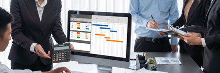 Project planning software for brisk business project management on the computer screen showing timeline chart of the team projectの写真素材