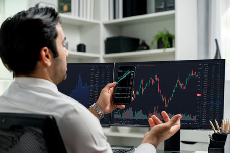 Trader businessman searching on smartphone, analyzing in dynamic stock exchange investment screen on...