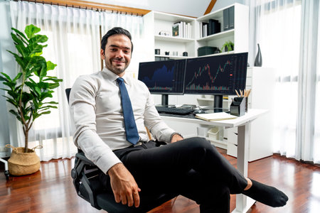 Profile of successful in trader businessman looking at camera with two stock exchange investment screens with good-looking pose in dynamic financial technology graph stock market at office. Surmise.の写真素材