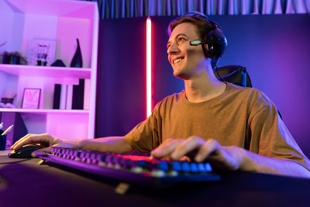 Host channel of gaming smart streamer playing online game to be winner, wearing headphone with...