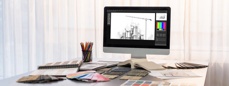 Interior designer workspace table and architecture software on laptop screen with mood board...